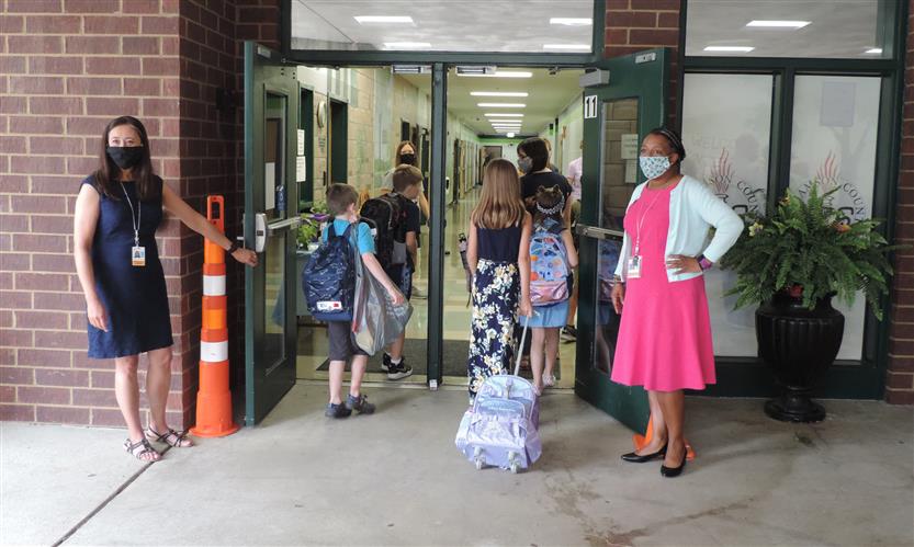 Principals welcome students as they walk through the doors